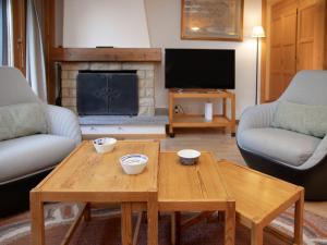 a living room with a coffee table and a fireplace at Apartment Parc C013 by Interhome in Champex +31 photos