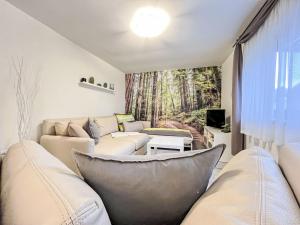 a living room with white furniture and a window at Apartment Hartmann by Interhome in Laudenau
