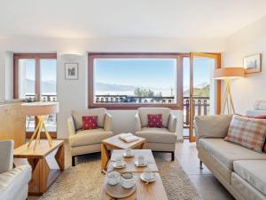 a living room with a couch and a table at Apartment Les Aiguilles Vertes Rez inférieur by Interhome in Crans-Montana +46 photos