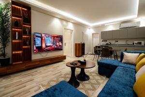 a living room with a couch and a table and a kitchen at Spacious room and hall in Sulaymaniyah 309 in Riyadh