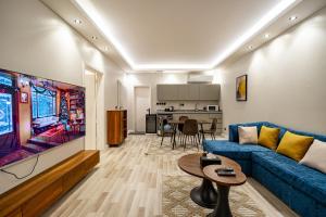 a living room with a blue couch and a tv at Spacious room and hall in Sulaymaniyah 309 in Riyadh