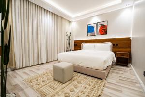 a bedroom with a large white bed and a rug at Spacious room and hall in Sulaymaniyah 309 in Riyadh