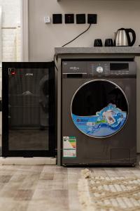 a microwave and a washing machine in a kitchen at Spacious room and hall in Sulaymaniyah 309 in Riyadh +10 photos