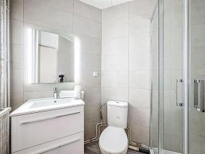 a bathroom with a toilet and a sink and a shower at Apartment Le Curling B - Val Claret-30 by Interhome in Tignes +17 photos