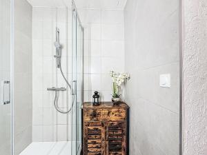 a bathroom with a shower and a table with flowers at Apartment Le Curling B - Val Claret-30 by Interhome in Tignes