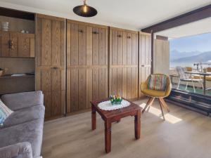 a living room with a couch and a table at Studio Jeanne D'Arc Apt- A-8 by Interhome in Crans-Montana