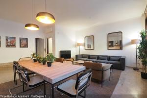 a living room with a table and a couch at Brera Apartments in Duomo in Milan