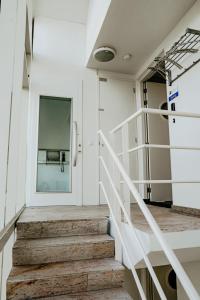 a staircase in a building with a door and a window at Apartment De Zeeparel by Interhome in Egmond aan Zee