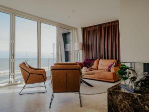 a living room with a couch and chairs at Apartment De Zeeparel by Interhome in Egmond aan Zee +31 photos