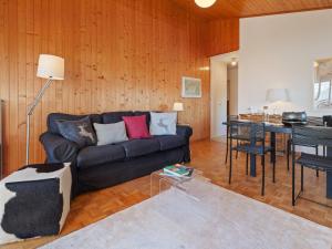 a living room with a couch and a table at Apartment Belmont Est 80 by Interhome in Vermala