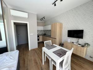 a living room with a white table and chairs at Double studio Petra B2-5 in Byala