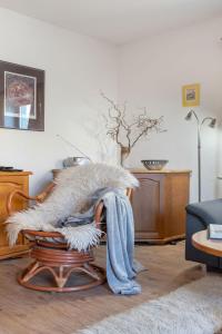 a person sitting in a rocking chair with a blanket at Holiday Home Kralovice by Interhome in Nebahovy
