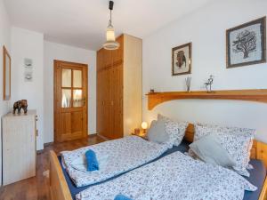 a bedroom with a bed with blue pillows at Holiday Home Kralovice by Interhome in Nebahovy