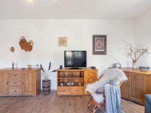 a living room with a tv and a chair at Holiday Home Kralovice by Interhome in Nebahovy