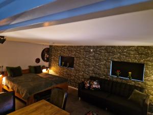 a living room with a bed and a couch at Grutsk op 12 in Drachten