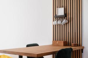 a wooden table with chairs next to a wall at Hike & Ski-in Ski-out Mountain View Apartment for Family & Friends in Hinterstoder
