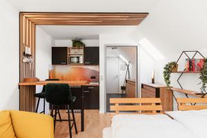 a kitchen and living room with a table and chairs at Hike & Ski-in Ski-out Mountain View Apartment for Family & Friends in Hinterstoder