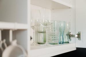 a cabinet filled with glasses on a shelf at Hike & Ski-in Ski-out Mountain View Apartment for Family & Friends in Hinterstoder +36 photos