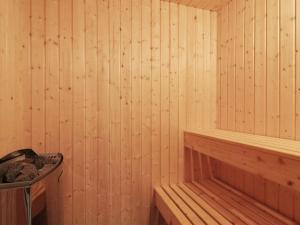a wooden sauna with a tub and a trash can at Holiday Home Franke - 1-1km from the sea by Interhome in Hjørring