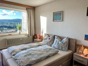 a bedroom with a bed and a large window at Apartment Hochstein by Interhome in Haidmühle