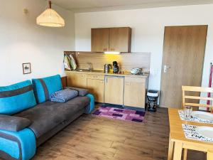a living room with a couch and a kitchen at Apartment Hochstein by Interhome in Haidmühle
