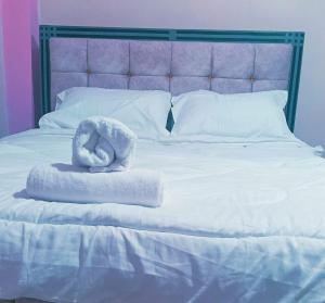 Ένα ή περισσότερα κρεβάτια σε δωμάτιο στο Sereni Homestays