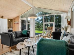 a living room with a couch and a table at Holiday Home Delco - 200m from the sea by Interhome in Hals +22 photos