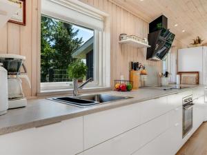 a kitchen with a sink and a window at Holiday Home Delco - 200m from the sea by Interhome in Hals