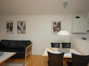 a dining room with a table and a table and chairs at Apartment Runhild - 100m from the sea by Interhome in Hals