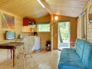 a kitchen and a living room with a couch and a table at Holiday Home Ascen - 300m from the sea by Interhome in Læsø +12 photos