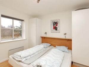 a white room with two beds in it at Apartment Enni - 100m from the sea by Interhome in Hals