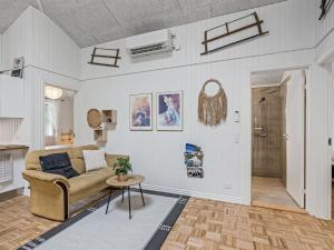 a living room with a couch and a table at Holiday Home Veijo - 400m to the fjord by Interhome in Spottrup +28 photos