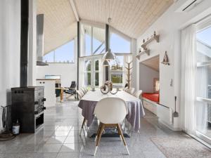 a kitchen and dining room with a table and chairs at Holiday Home Thrugels - 600m from the sea by Interhome in Hadsund