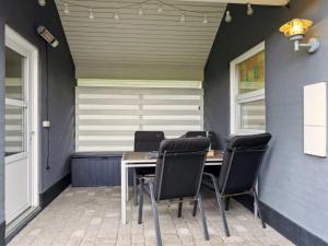 a table and chairs sitting on a patio at Holiday Home Thrugels - 600m from the sea by Interhome in Hadsund +14 photos