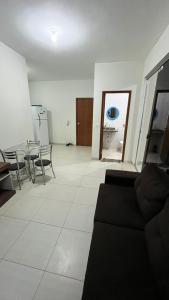 a living room with a couch and a table and chairs at Apartment Poncho Verde - Primavera do Leste, Mato Grosso in Primavera do Leste