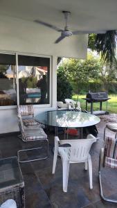 a patio with a glass table and chairs at Hotel en Tequesquitengo Gran Horizonte in Tequesquitengo