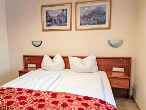 a bedroom with a bed with two pillows on it at Holiday Home Gästehaus Beretta by Interhome in Achenkirch +34 photos