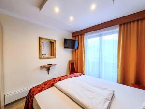 a bedroom with a bed and a window at Holiday Home Gästehaus Beretta by Interhome in Achenkirch