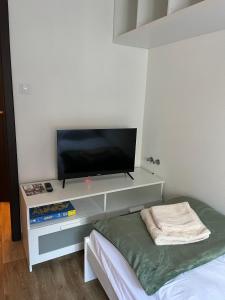 a room with a flat screen tv on a shelf at Apartmán Husova in Prachatice