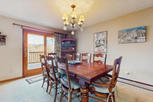 a dining room with a wooden table and chairs at Timber Creek #100 in Podunk