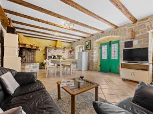 een woonkamer met een bank en een tafel bij Holiday Home Franz by Interhome in Potpićan