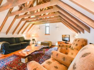 a living room with a couch and a table at Holiday Home The Granary by Interhome in Invermoriston +54 photos