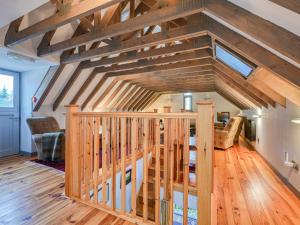 a large room with wooden stairs in a house at Holiday Home The Granary by Interhome in Invermoriston