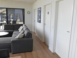 a living room with a couch and a table at Holiday Home Hildegunda - 600m from the sea by Interhome in Sjølund