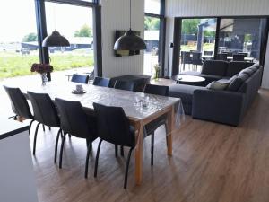 a dining table and chairs in a living room at Holiday Home Hildegunda - 600m from the sea by Interhome in Sjølund
