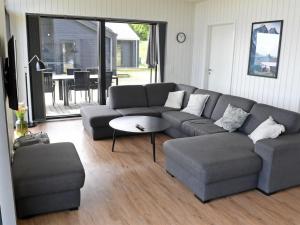 a living room with a couch and a table at Holiday Home Hildegunda - 600m from the sea by Interhome in Sjølund