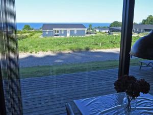 a screened in porch with a view of a house at Holiday Home Hildegunda - 600m from the sea by Interhome in Sjølund +22 photos
