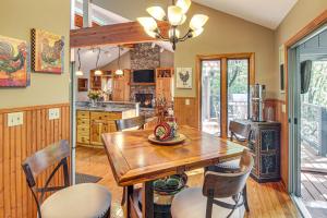 a kitchen and dining room with a wooden table and chairs at Festive Lakefront Escape Blue Ridge Holiday Home in Brevard