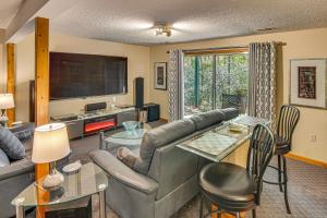 a living room with a couch and a table at Festive Lakefront Escape Blue Ridge Holiday Home in Brevard