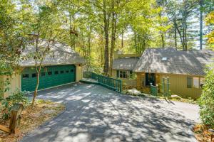 a house with a green garage and a driveway at Festive Lakefront Escape Blue Ridge Holiday Home in Brevard